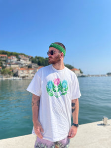 man wearing white misfit painted t-shirt with green halara headband