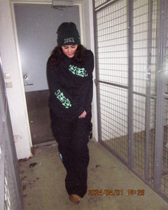 woman wearing black oversized growth longsleeve showing both sleeve graphics