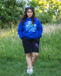woman wearing blue oversized lifted living sweater with black euphoria shorts
