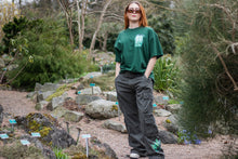 Load image into Gallery viewer, woman wearing green baggy roboflower graphic cargos with oversized green fly outside the jar t-shirt