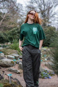 woman wearing green oversized fly outside the jar butterfly graphic t-shirt with green oversized roboflower cargos