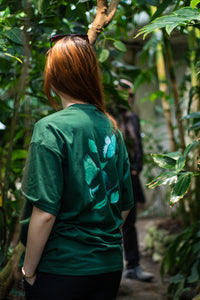 woman wearing green oversized fly outside the jar t-shirt back butterfly graphic