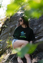 Load image into Gallery viewer, woman wearing green oversized overload t-shirt with short jean shorts