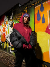 Load image into Gallery viewer, woman wearing red mindcontrol hoodie and purple DFKT logo beanie with black north face jacket