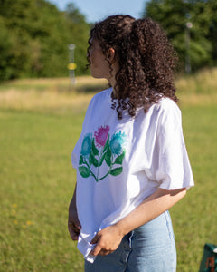 woman wearing tucked in white misfit painted t-shirt 