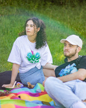 Load image into Gallery viewer, woman wearing tucked in white misfit painted t-shirt at a picnic
