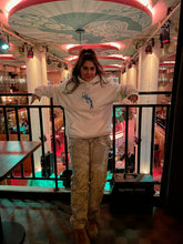 Load image into Gallery viewer, woman wearing white graphic Euphoria hoodie with camo pants