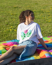 Load image into Gallery viewer, woman wearing white misfit painted t-shirt at a picnic