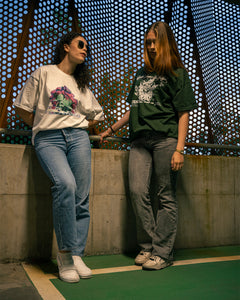 women wearing a green oversized onecolor graphic t-shirt and white oversized roboflower v3 t-shirt 2