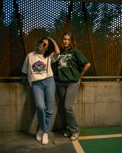 women wearing a white oversized roboflower v3 t-shirt and green oversized onecolor graphic t-shirt