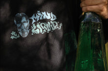 Load image into Gallery viewer, Black Mindliquid logo hoodie graphic closeup with potion bottle next to it
