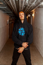 Load image into Gallery viewer, Man wearing Oversized Black Bubbles Graphic Hoodie with orange bandana