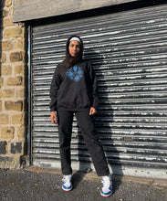 Load image into Gallery viewer, Woman wearing Black Bubbles Hoodie with black jeans and Blue shoes