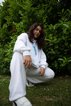 Load image into Gallery viewer, Woman wearing oversized white Euphoria Hoodie with all white outfit