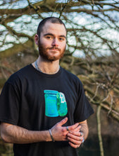 Load image into Gallery viewer, man wearing a black oversized panic control t-shirt 
