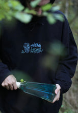 Load image into Gallery viewer, man wearing oversized black mindliquid logo hoodie while holding green potion bottle