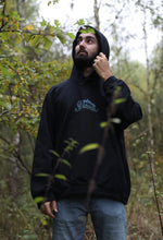 Load image into Gallery viewer, man wearing oversized black mindliquid logo hoodie with hoodie up