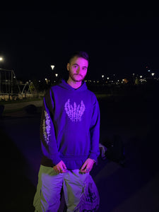 man wearing purple lavender hoodie showing sleeve and chest graphic