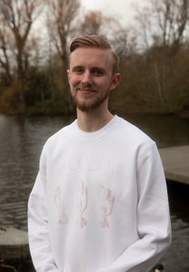 man wearing white oversized graphic thinker sweater