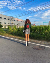 Load image into Gallery viewer, woman wearing green oversized stress tee with checkered skirt